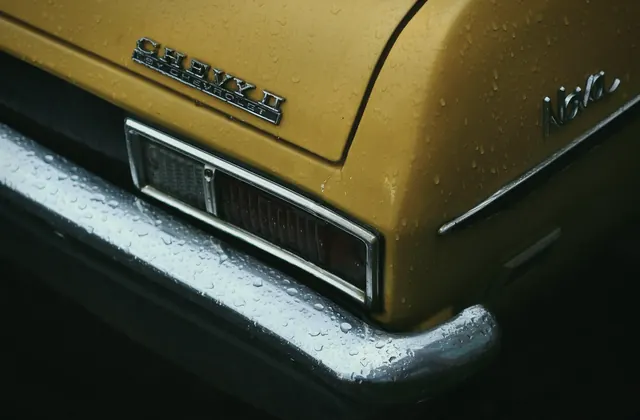 Rain on a classic collector car badge and chrome